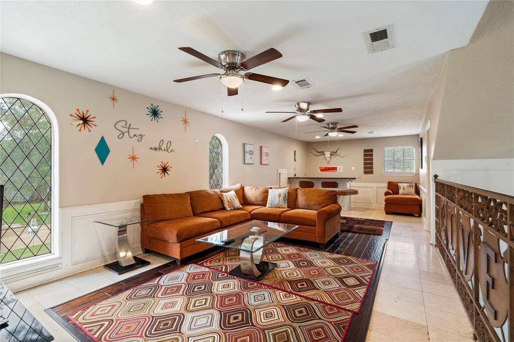 Spacious upstairs game room with room to relax, entertain, or create the ultimate media or play space—complete with a built-in bar and flexible layout.