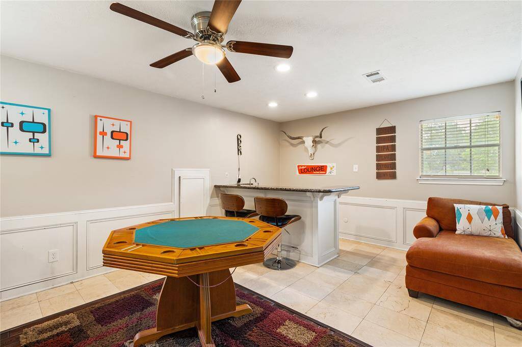 Upstairs lounge area with a built-in bar and space for game nights or casual hangouts. Perfect for entertaining with easy flow to the rest of the second floor.