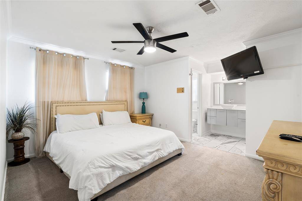 Upstairs guest suite with its own private bathroom and modern vanity. A comfortable setup for visitors