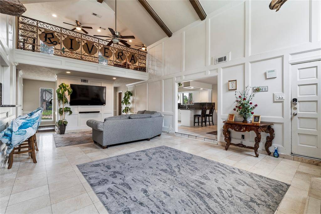 High cathedral ceilings and a spacious open layout make this living area the heart of the home—perfect for relaxing or entertaining, with seamless flow into the kitchen and wet bar.