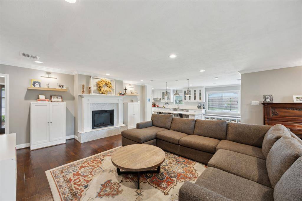 Another perspective of the family room showing the built ins on either side of the fireplace. Note the engineered hardwood floors which continue throughout the home.