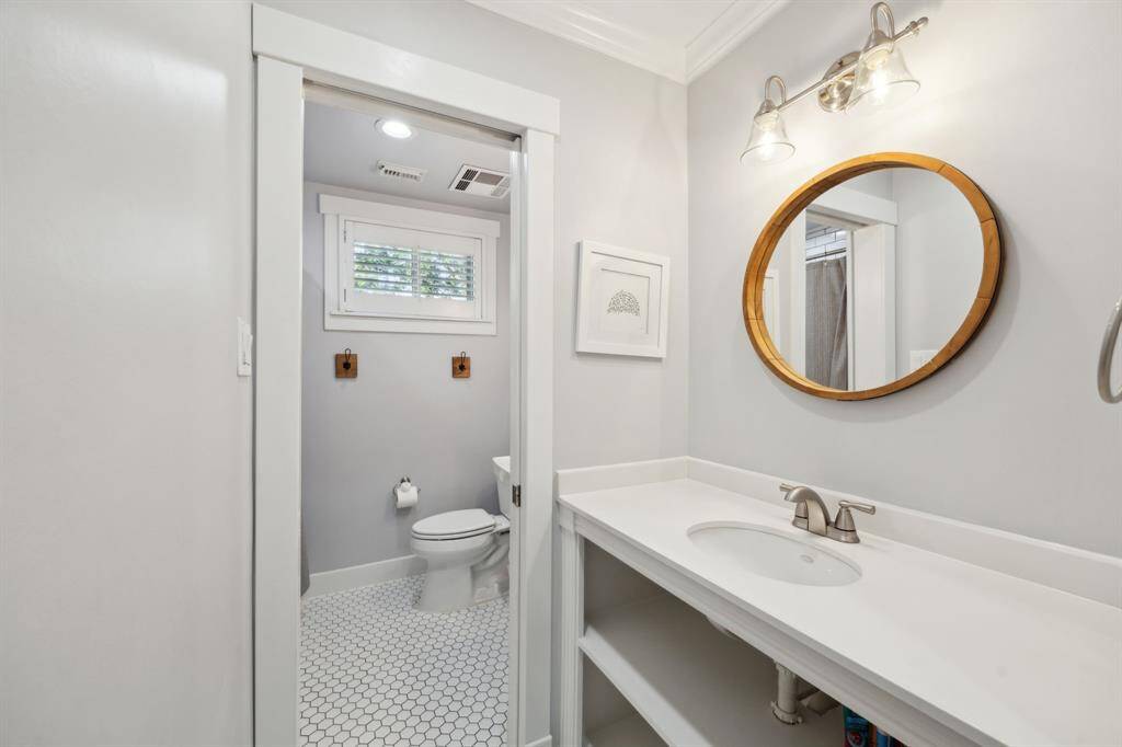 Updated secondary bath features TWO sinks, linen and toiletry storage, and a tub/shower combo.