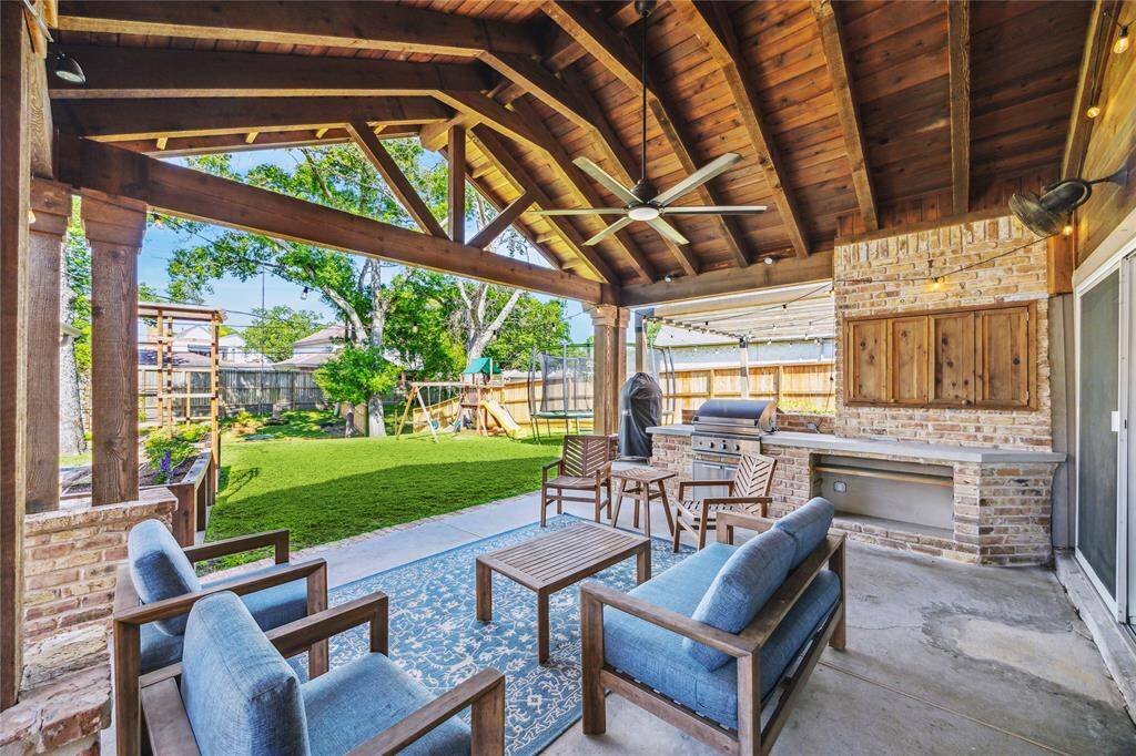 The outdoor living offers summer kitchen with built-in grill, custom TV enclosure, and a separate fire pit space. Enjoy incredible views of your private backyard.