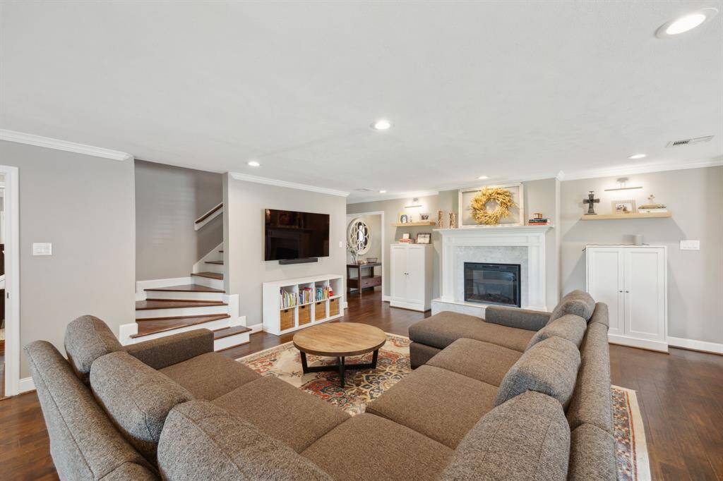Perspective of the large family room and the stairwell leading to the guest bedrooms.