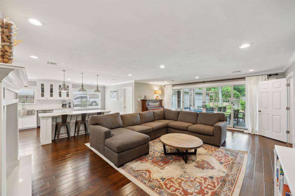 The family room is the heart of the home and features Renewal by Anderson sliding glass doors which open up to the outdoor living.