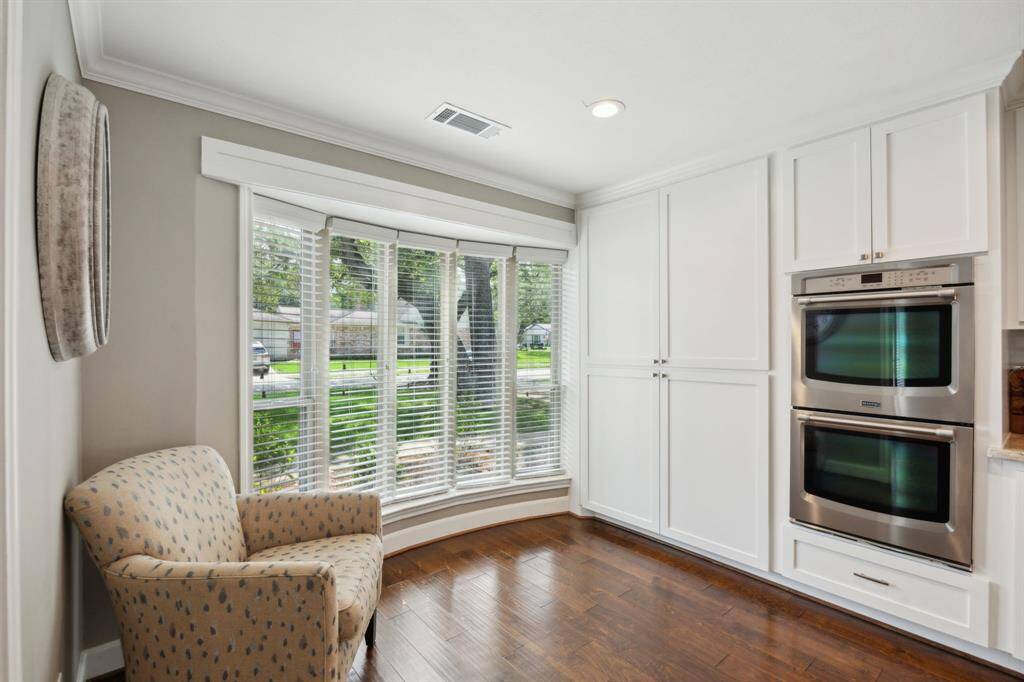 Windows overlook the beautifully manicured front yard and allow tons of natural light into the kitchen. Note the custom storage with shelving and drawers for easy organization.