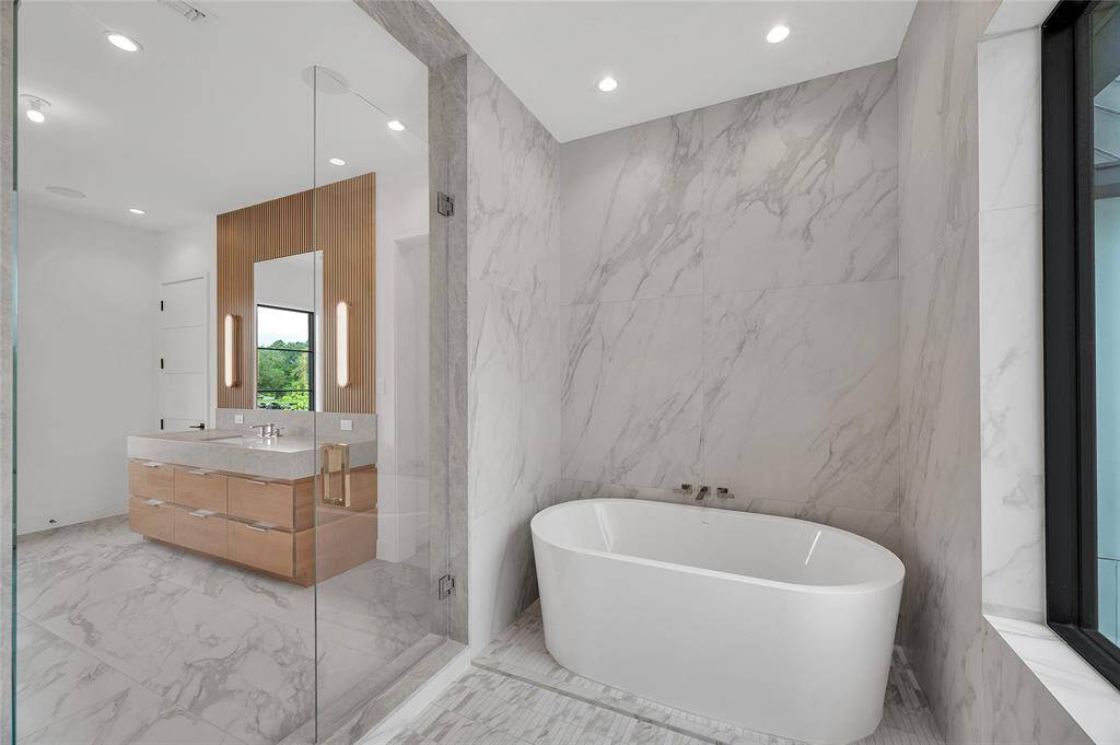 [Primary Bath]Wet room Bain Ultra soaking tub. Note quartzite walls and floor.