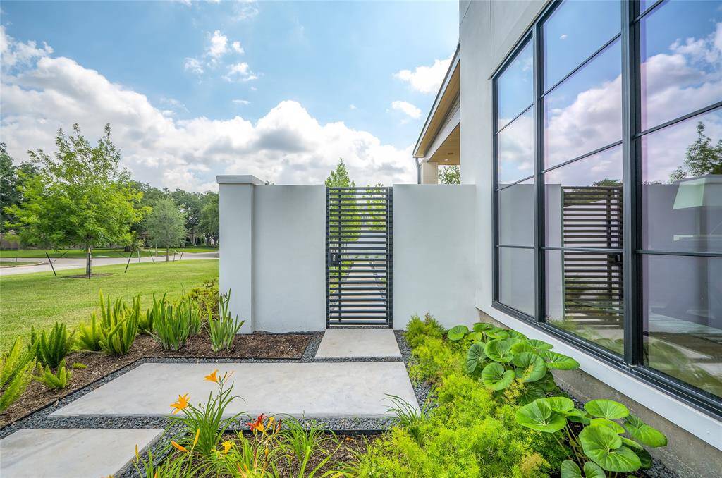 [Pedestrian Gate]This iron gate allows entry into the side yard/pool/patios from the front yard.