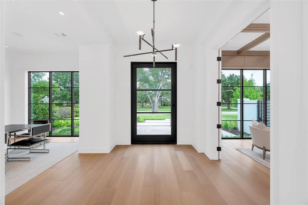 [Foyer]A reverse view of the front door reveals the dining room (left) and study (right). Note Quaker picture windows overlooking the front approach and gardens.