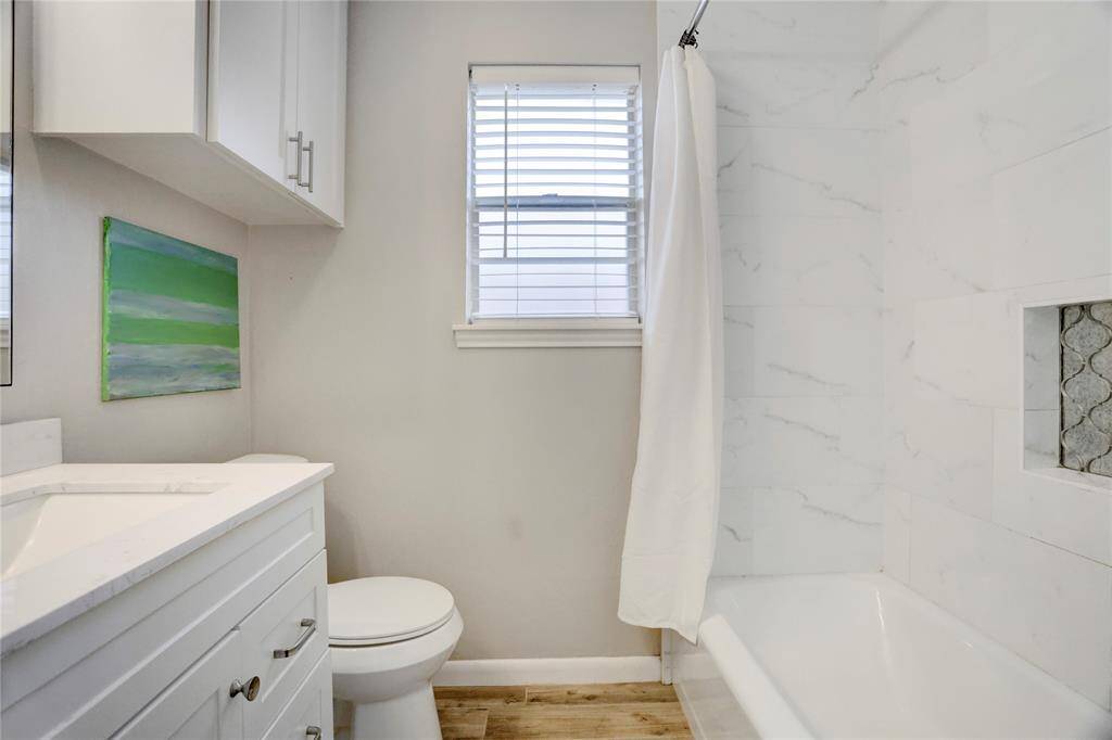 Primary bathroom with updated tub/shower combo.