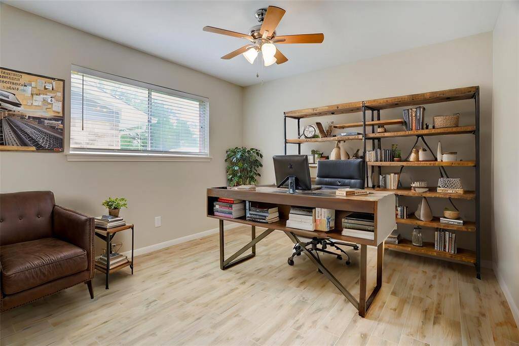 The first of two secondary bedrooms, virtually staged as a study, faces the front of the house.