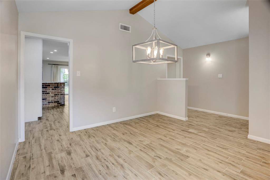 Another angle of the dining room showing the foyer and entry into the kitchen.