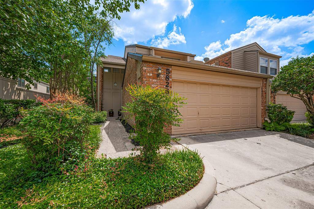 An end unit in the Tanglegrove Townhomes community, 5825 Sugar Hill Drive offers picturesque serenity with easy access to everything the city has to offer.