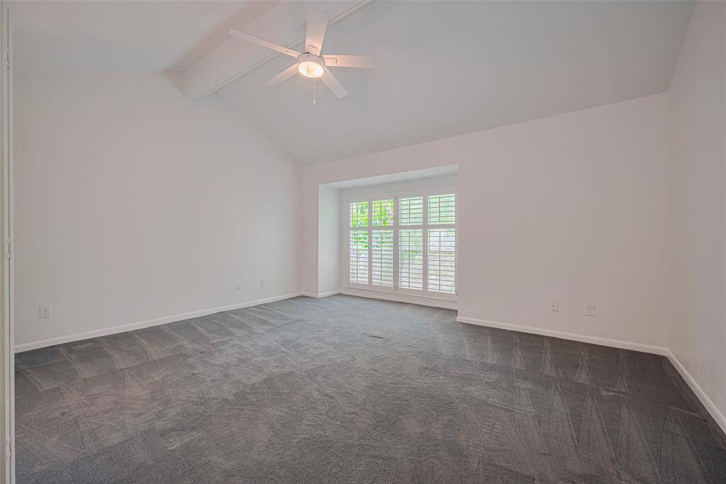 The large primary bedroom features vaulted ceilings and lots of natural light or close the plantation shutters for extra privacy.