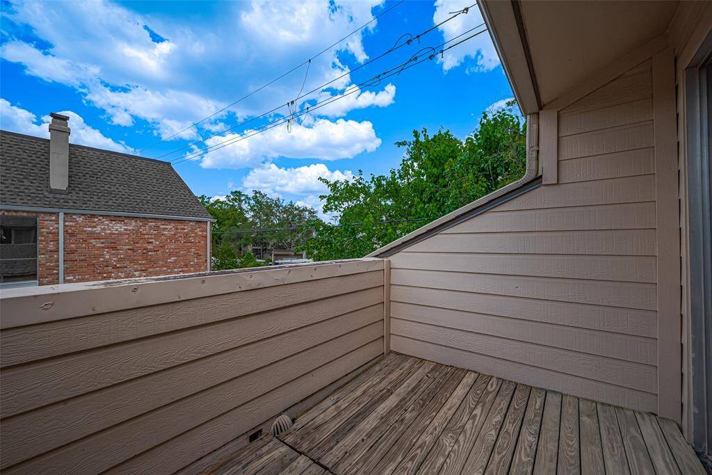 The private balcony off the secondary bedroom provides a quiet outdoor space for morning coffee or an evening nightcap.