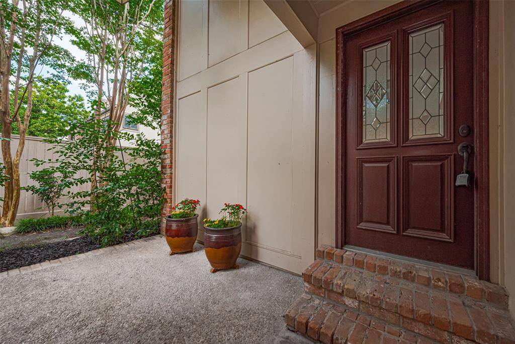 This end unit features a private front porch surrounded by lush greenery.