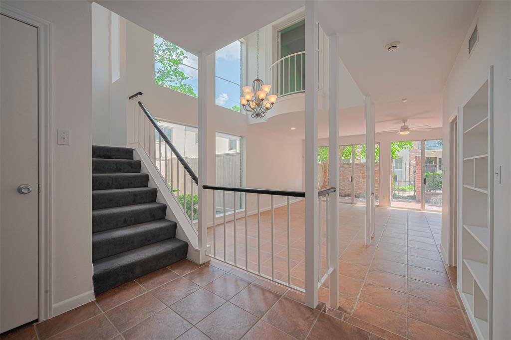 The entry way at 5825 Sugar Hill leads upstairs to the bedrooms or down a step to the dining room and living room.