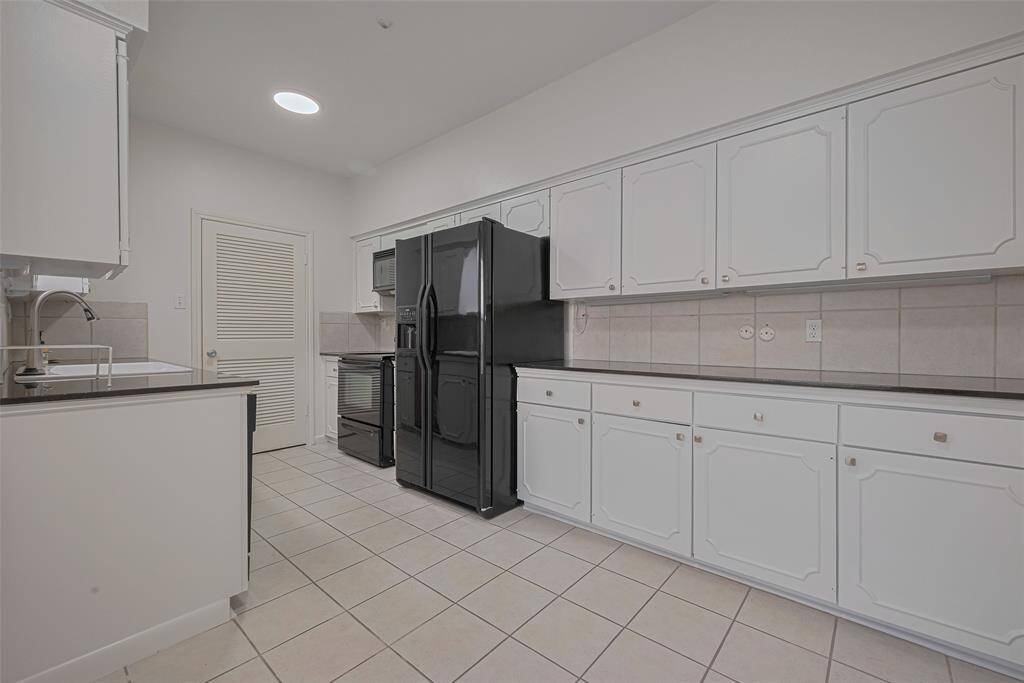 The kitchen features lots of counter space with a utility room/pantry as well.
