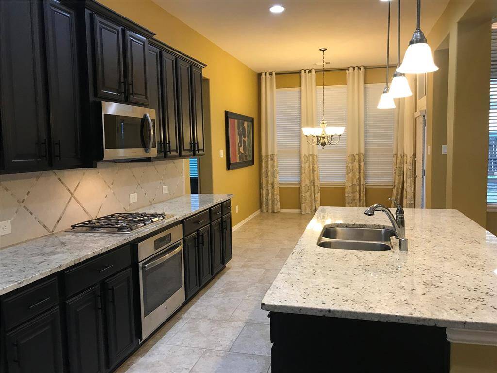 Check out the gorgeous Granite Countertops with beautiful Backsplash, all Appliances are Stainless Steel