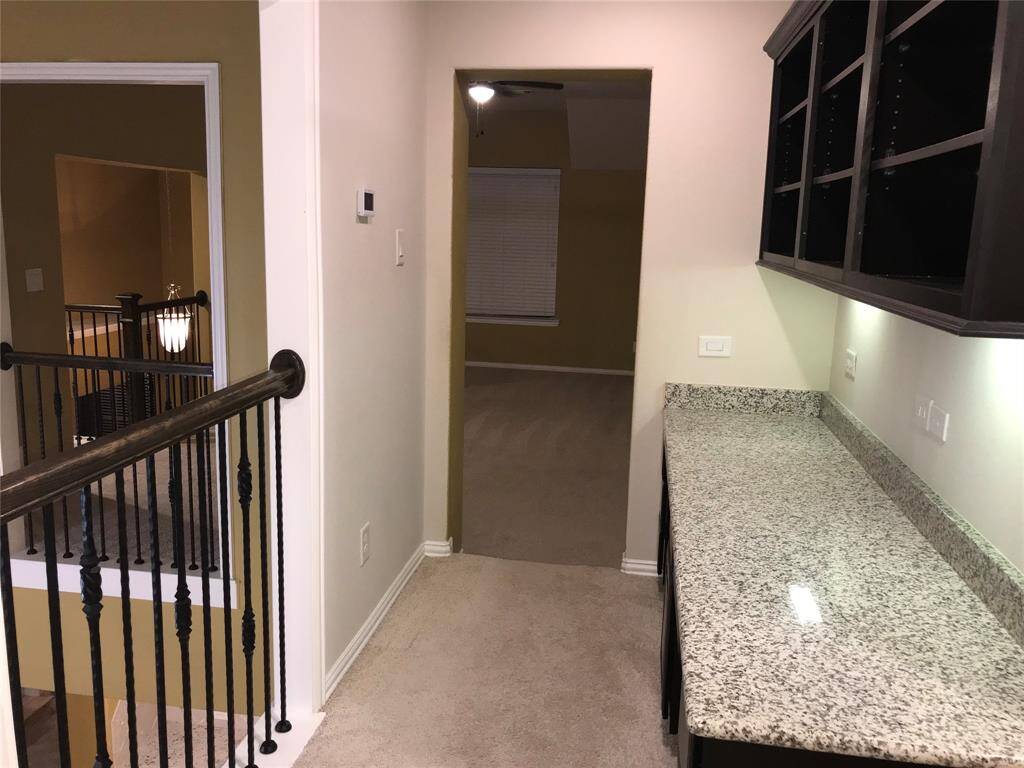 BEAUTIFULLY LANDSCAPED COVERED BACK PATIO WITH BUILT-IN GAS GRILL AND ROCK-BEDS