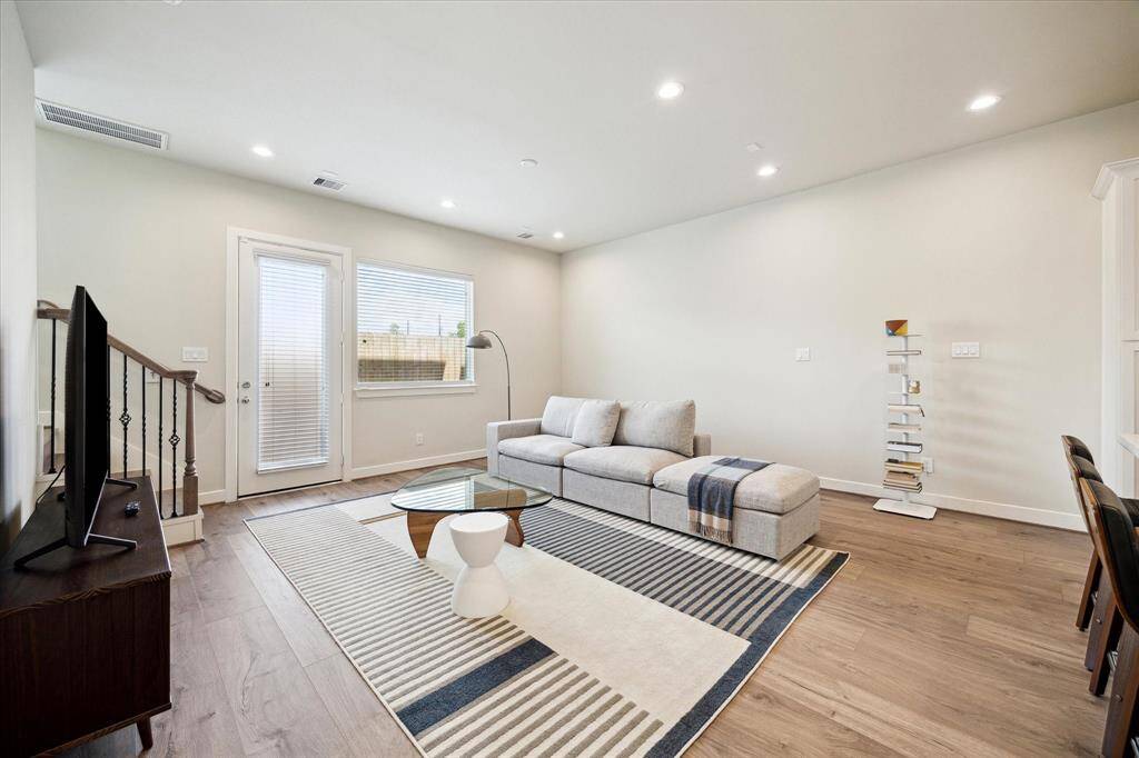 Spacious living room view from the back door, seamlessly connected to the kitchen — ideal for open-concept living.