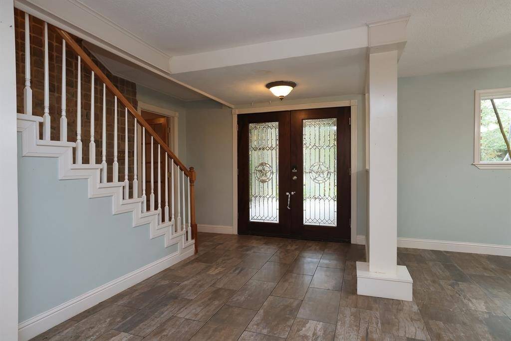 Just off the Foyer is the front set of stairs and the Home office.