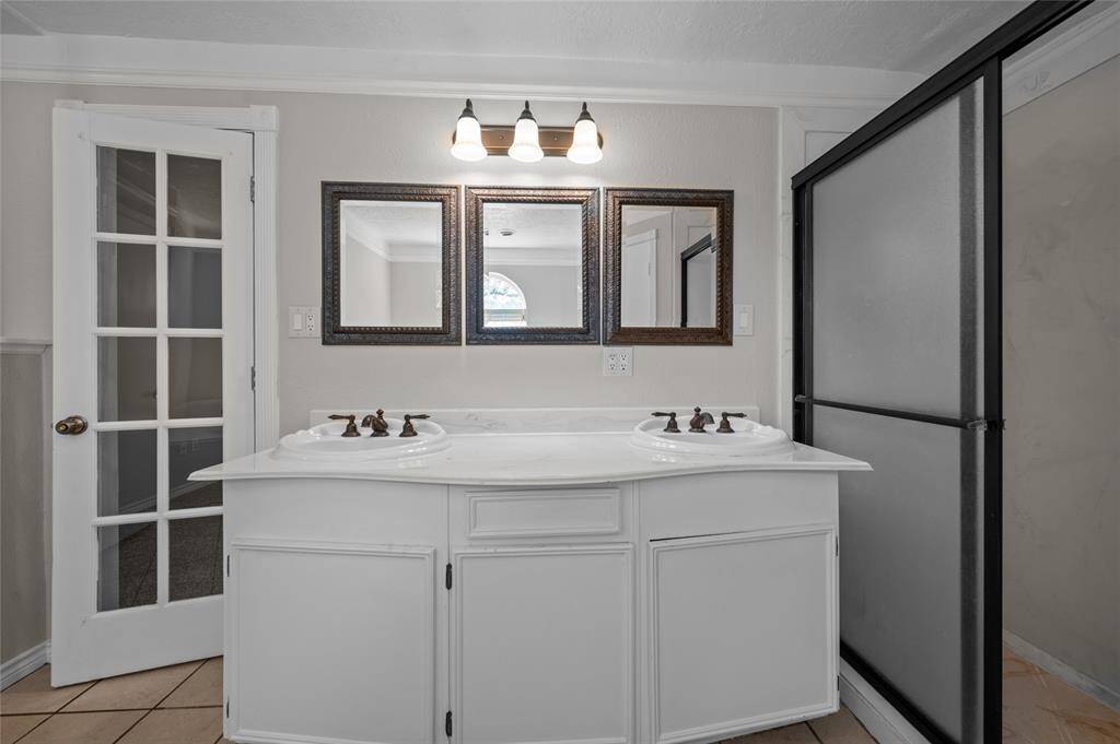 Primary bath with double sinks and separate shower.