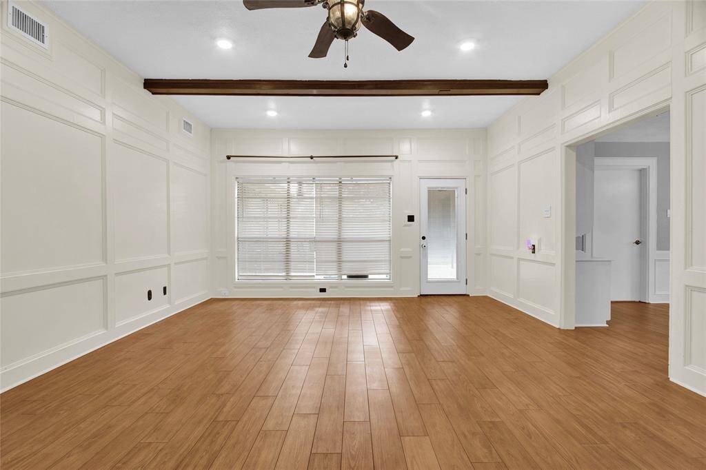 Bask in the abundant natural light from the expansive windows in this inviting space.