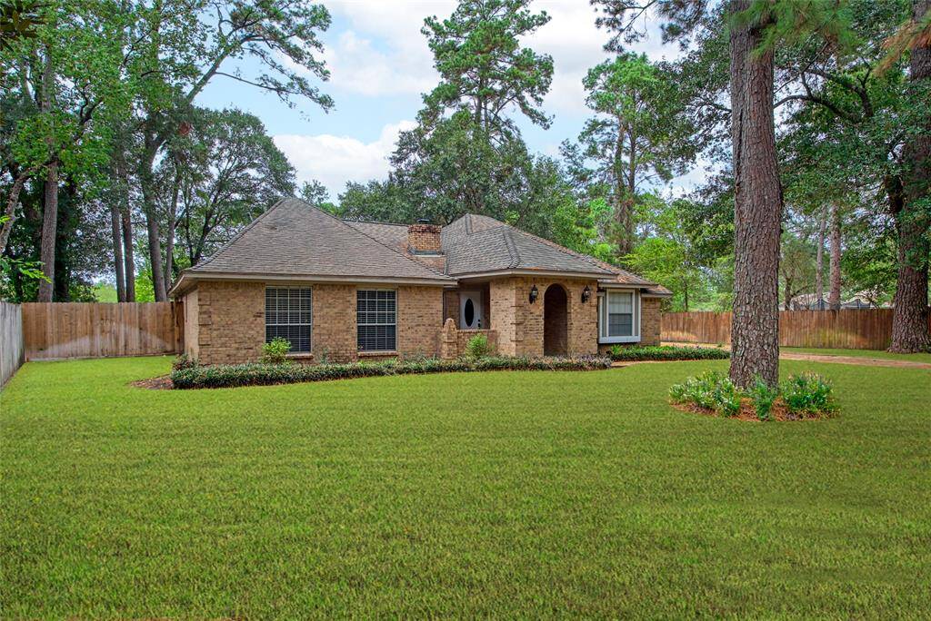Charming Elegance at 6214 Oak Masters: Discover your dream home nestled among lush greenery, featuring a classic brick facade, sophisticated architecture, and a serene, expansive lawn. A perfect blend of comfort and style awaits you.