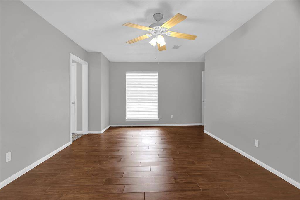 Spacious Primary Suite with Elegant Hardwood Look Floors and Ample Natural Light.
