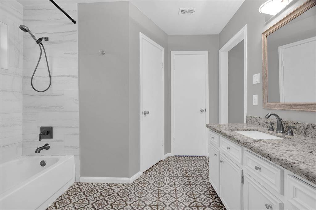 Elegant Primary Ensuite with modern fixtures, designer tiling, and a spacious walk-in shower.