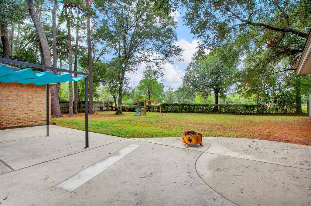Expansive entertaining patio amidst serene greenery.