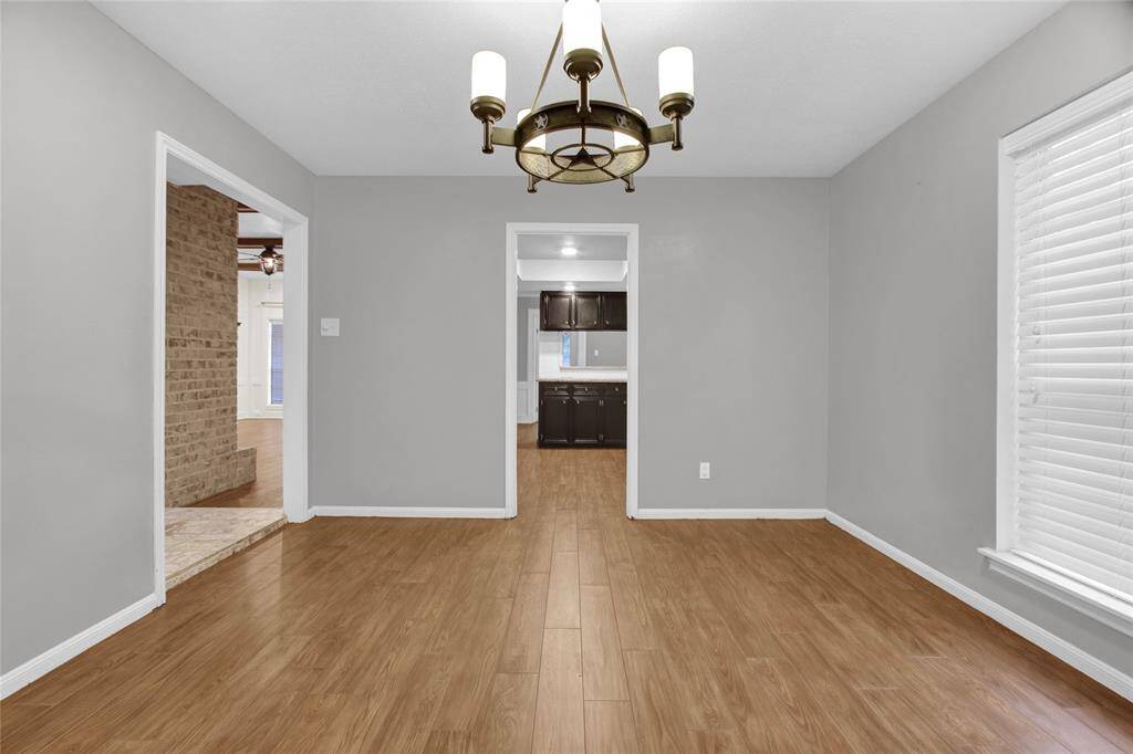Elegant Dining Space with Modern Lighting and Hardwood Floors