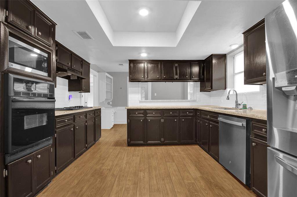 Modern kitchen featuring sleek stainless steel appliances and elegant granite countertops.