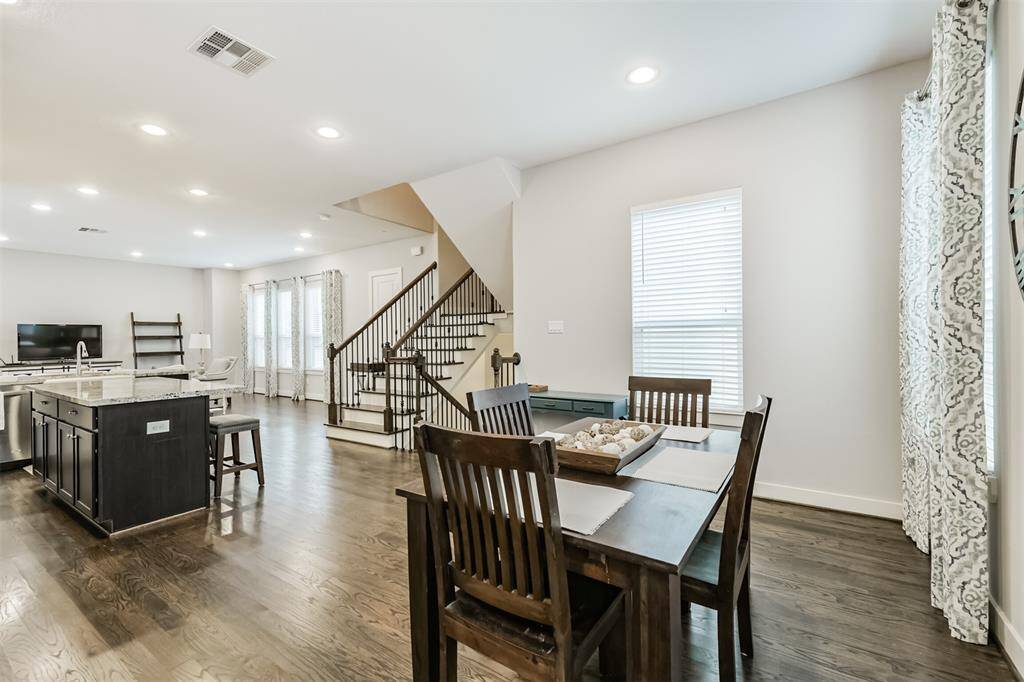 The second floor features tall ceilings, natural light, and real oak floors stained in a neutral warm grey.