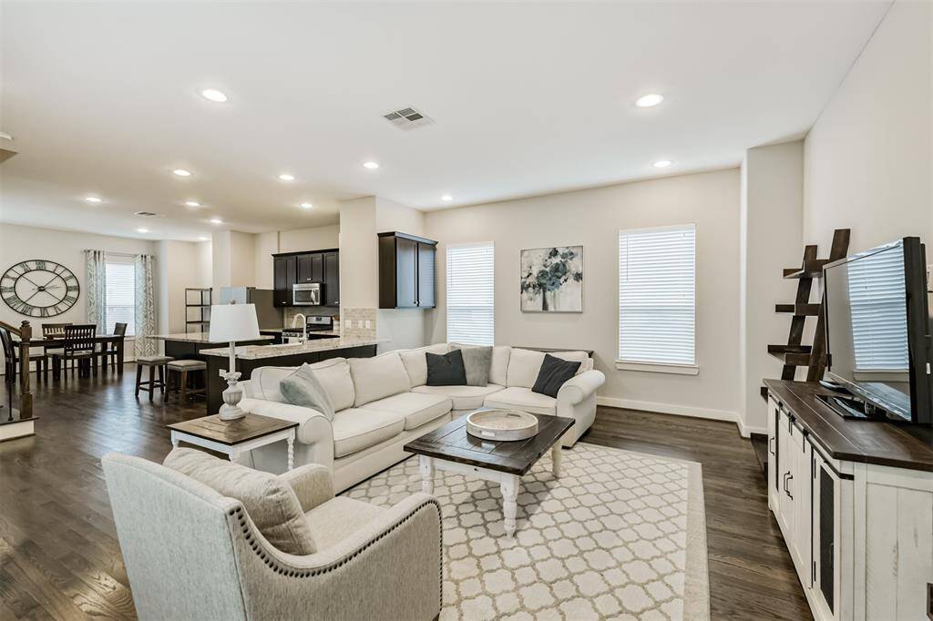 The second floor is open while still having sectioned areas for living, dining, and kitchen.