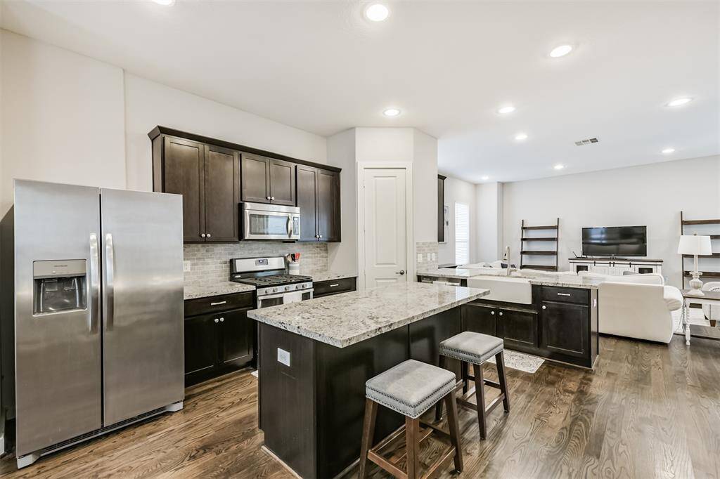 The kitchen has excellent counter space with a nice island and stainless steel appliances - all of which STAY with the home. Gas cooking - yay!