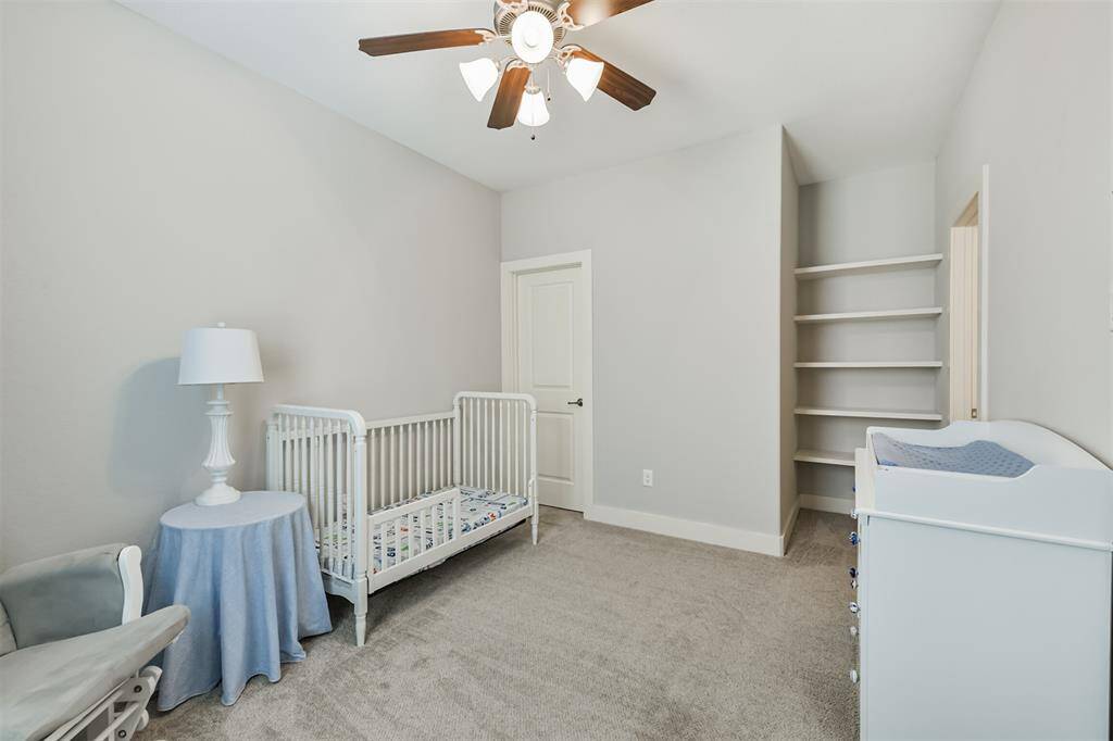 Book shelves allow for more storage in this bedroom.