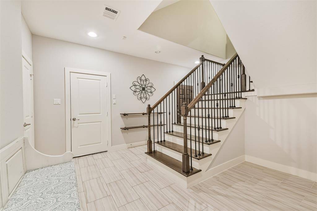 Large entry way has room for storage, a shoe bench, and decor. The first floor has access to the two car garage and secondary bedroom.