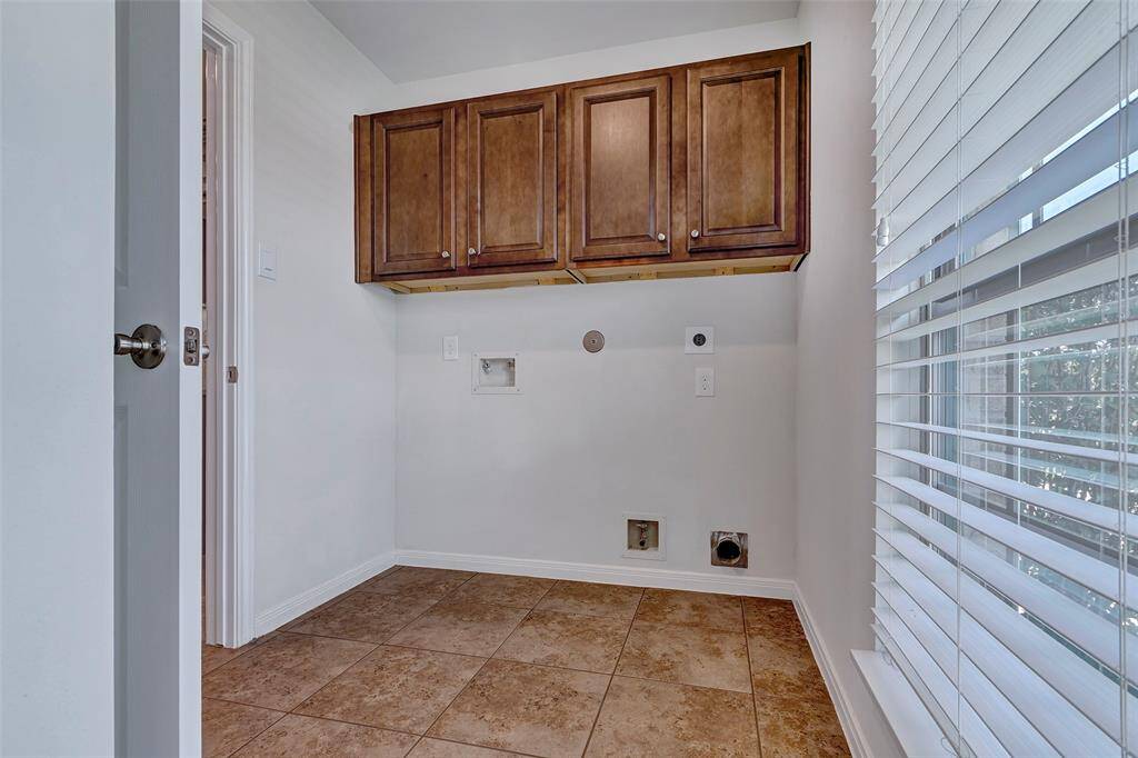 Large utility room with added wall cabinets.
