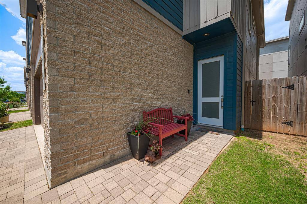 Charming private entry with paved walkway, cozy seating area, and direct access to the backyard—perfect for morning coffee or evening unwinds in your own peaceful retreat.