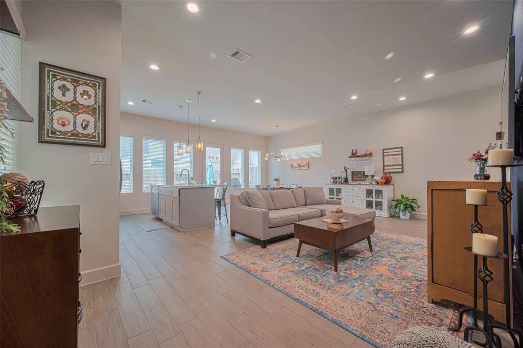 Experience seamless open-concept living—this thoughtfully designed layout features abundant natural light, elegant flooring, and a central kitchen island perfect for hosting or everyday comfort.