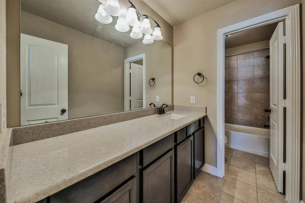 The secondary bath boasts and extended vanity to make getting ready a breeze.