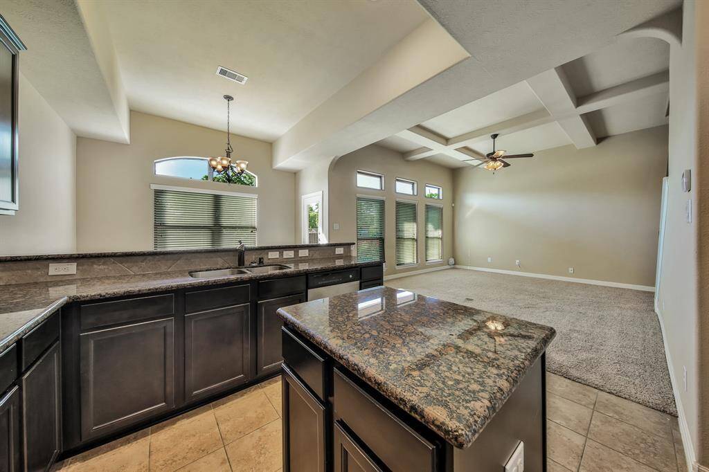 This upgraded plan includes a center island, beautiful granite, and a tile backsplash.