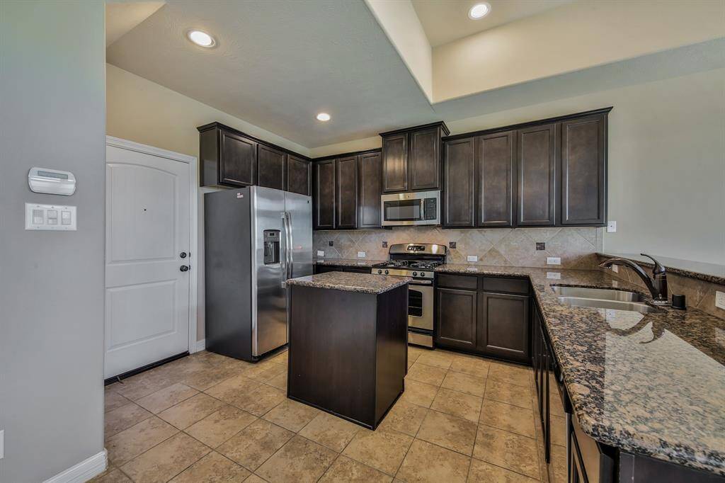 All stainless steel appliances including a gas range, built in microwave, dishwasher and refrigerator stay with the home.