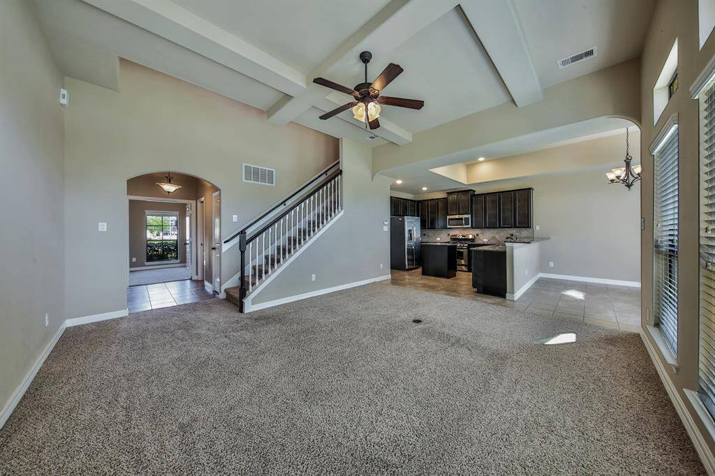 The family room is open to the kitchen. A beautiful artisan ceiling adds character and dimension to the space.