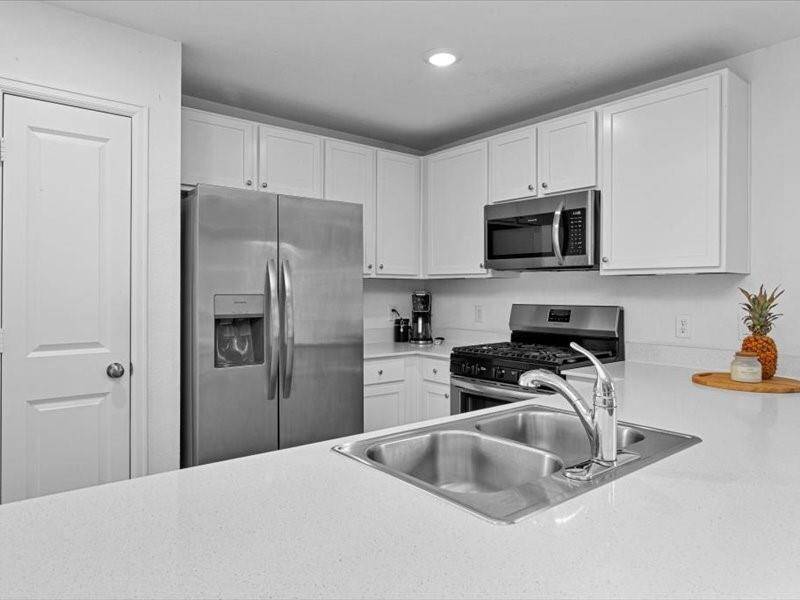 The kitchen offers plenty of counter space, making it a dream for the family chef to prepare meals with ease.