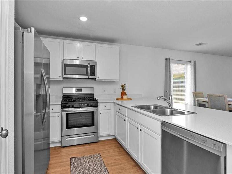 The refrigerator is included with the home, perfectly matching the other sleek stainless steel appliances for a cohesive, modern kitchen look.