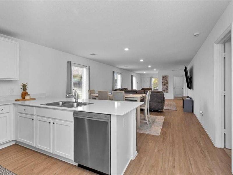 Enjoy a seamless flow from the kitchen, where you can take in views of the dining room and family room — creating an open and connected space perfect for entertaining and family gatherings.
