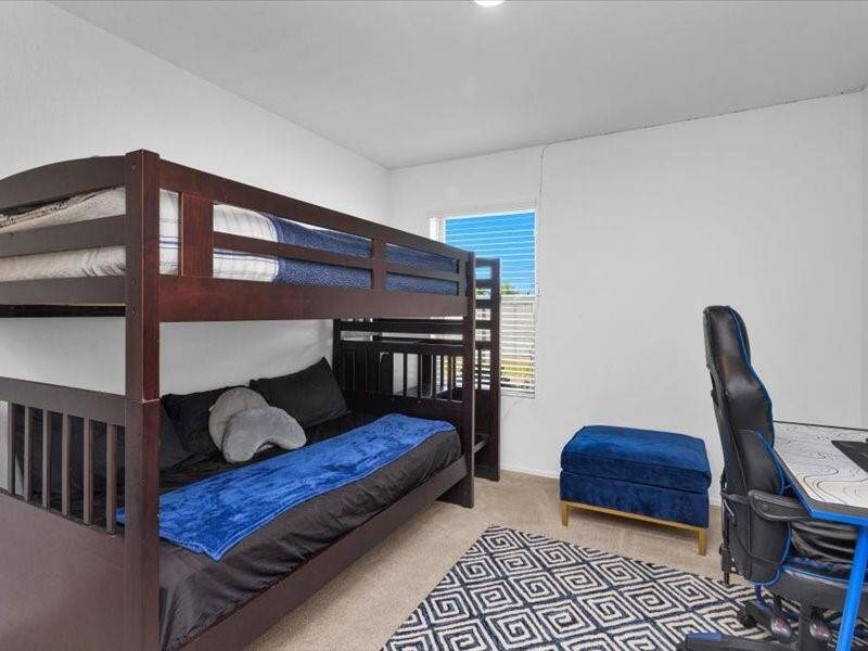 Secondary Bedroom 1 is bright and inviting, with plenty of space for a bed and personal touches. It’s the perfect room for family, guests, or a home office.